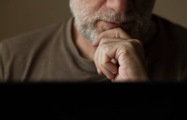 Portrait of adult man using laptop in room